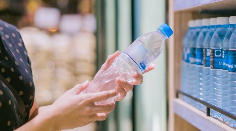 woman holding bottled water